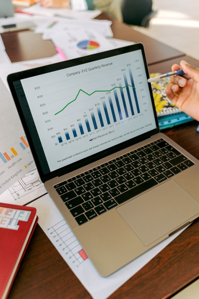 Offerings A close-up view of a laptop displaying business analytics and revenue charts.